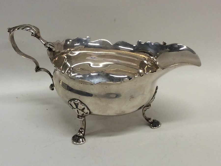 A Georgian silver sauce boat with card cut rim. Lo