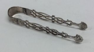 A pair of Georgian silver cast sugar tongs decorat