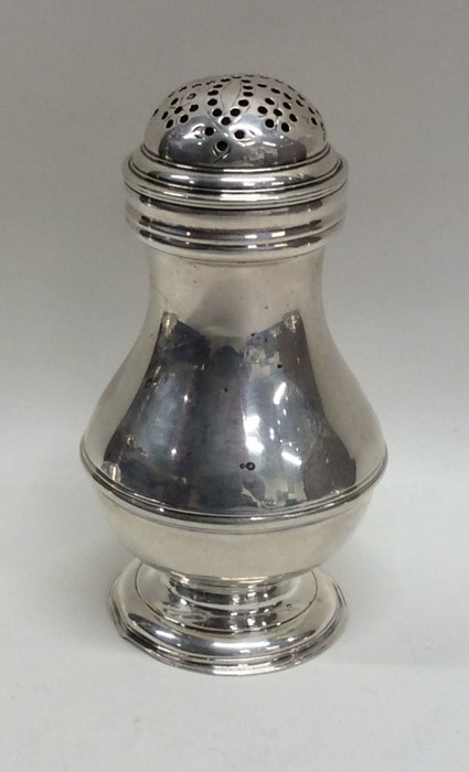 A Georgian silver baluster shaped bun pepper. Lond