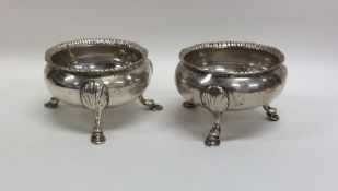 A pair of Georgian silver salts on cabriole legs.