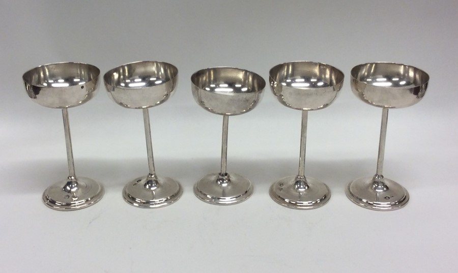 A set of five Continental silver shot glasses. App