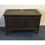 An oak narrow coffer with carved front to hinged t