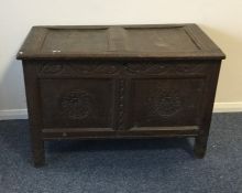 An oak narrow coffer with carved front to hinged t