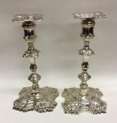 A good matched pair of Georgian cast silver candle