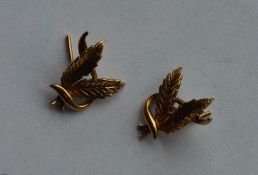A pair of 9 carat earrings in the form of leaves.