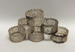 A set of six Continental silver filigree napkin ri