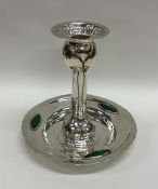 A stylish silver and enamel candlestick of texture