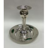 A stylish silver and enamel candlestick of texture