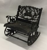 A child's cast iron mounted garden rocking chair.