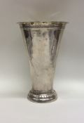 A tall tapering silver vase of textured form. Mark
