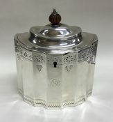 A good bright cut Georgian silver hinged top tea c