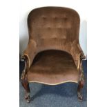 A Victorian spoon back armchair with scroll decora