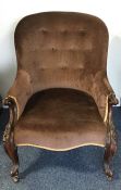A Victorian spoon back armchair with scroll decora