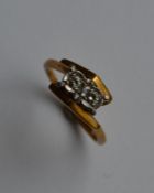 An 18 carat platinum and gold two stone diamond cr