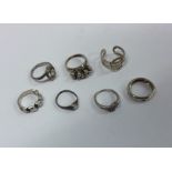 A collection of seven silver mounted rings. Approx