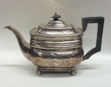 A Georgian silver teapot on ball feet with floral