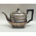 A Georgian silver teapot on ball feet with floral