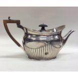 A silver half fluted teapot. London. Approx. 705 g