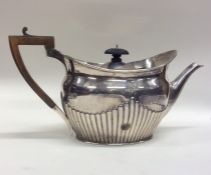 A silver half fluted teapot. London. Approx. 705 g