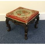 A Victorian scroll decorated stool with upholstere