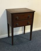 A narrow two drawer side table on tapering support