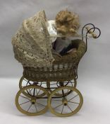 A small old child's pram together with a porcelain