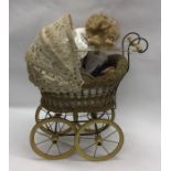 A small old child's pram together with a porcelain