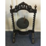 An old carved wooden gong. Est. £40 - £60.