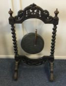 An old carved wooden gong. Est. £40 - £60.