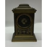 A good brass mantle clock attractively decorated w