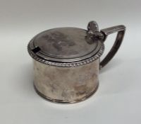 A Georgian silver circular hinged top mustard pot