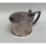 A Georgian silver circular hinged top mustard pot