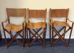 A set of four suede seated director's chairs by Ni