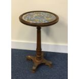 A Victorian cylindrical table on bun feet. Est. £2