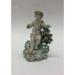 An Antique model of a cherub on scroll base decora