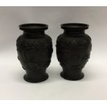 A good pair of heavy brass vases decorated with dr