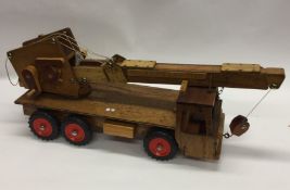 A child's wooden crane. Est. £20 - £30.