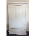 A painted pine two door wardrobe with drawer to ba