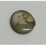 An oval gold mounted miniature of a gentleman in t