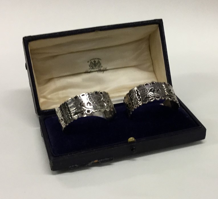 A pair of Continental silver napkin rings in fitte