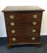 A Georgian mahogany chest of four drawers with bra