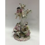 A Meissen style of group of figures on circular ba