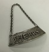 A large silver wine label for 'Sherry' of textured