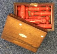 A rosewood box containing miniature skittles. Est.