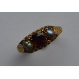 An Antique garnet and pearl ring attractively engr