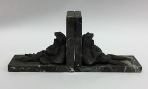 A pair of unusual bookends mounted with dozing toa