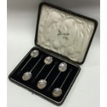 A boxed set of six silver bean top coffee spoons.