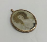 An attractive oval gold framed miniature of a lady