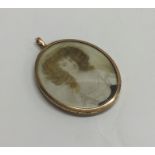 An attractive oval gold framed miniature of a lady