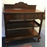 A mahogany two drawer buffet on ball and claw feet